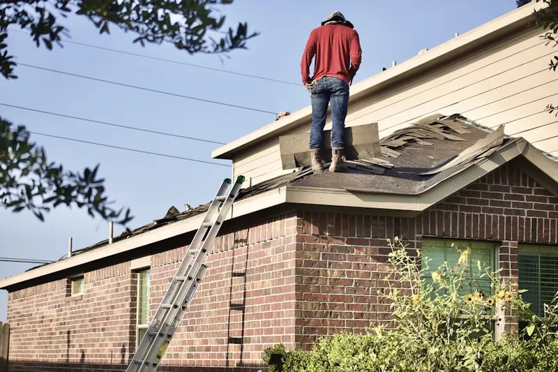 Professional roofer working on a residential roof in Spruce Run